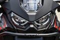 Close-up front view of Honda Africa Twin. Beautiful motorcycle of Japanese brand in black. Close-up of Headlights, predatory sight Royalty Free Stock Photo