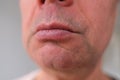 Close-up and front view of mouth of an old caucasian man in his sixties, with strong wrinkles, bright emotions on his face, male Royalty Free Stock Photo