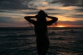 Close up Front view silhouette of attractive woman. Beautiful young girl with long hair walking on the beach, posing at Royalty Free Stock Photo