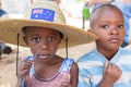 Close up front view of two unidentified African boys intrigued with the camera