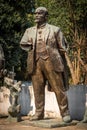 Close up front view of a worn broken bronze statue of Lenin in a city park in Tirana Albania.