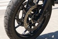 Close-up of the front wheel and brake system of a BMW F750 GS sports bike on the street. Royalty Free Stock Photo