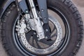 A close-up of the front wheel of a motorcycle with brakes Royalty Free Stock Photo