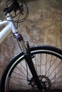 Close up front wheel tire of mountain bike against grungy cement Royalty Free Stock Photo