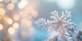 Close-up of a frosted snowflake with warm bokeh lights in the background