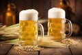 close-up of frothy beer in glass tankards on wooden table Royalty Free Stock Photo