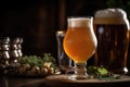 close-up of frothy draft beer, with glassware and hops in the background Royalty Free Stock Photo