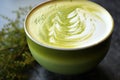 close-up of frothy matcha latte with latte art