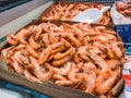 Close Up of frozen prawns in a supermarket refrigerated display case