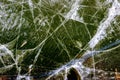 Close-up of frozen water surface with hoarfrost, bubbles trapped with natural cracks