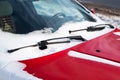 Close up of frozen windshield and red car wiper in winter Royalty Free Stock Photo