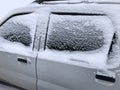 frozen winter car covered snow, view side window on snowy background Royalty Free Stock Photo