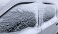 Frozen winter car covered snow, view side window on snowy background Royalty Free Stock Photo