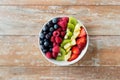 Close up of fruits and berries in bowl on table Royalty Free Stock Photo