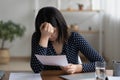 Close up frustrated Asian woman reading bad news in letter