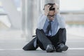 Close up frustrated stressed Asian business man touching head and feeling tired or sad his job