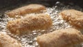 Close-up of Frying Breaded Kievsky Cutlets in Sizzling Oil.