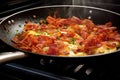 close-up of frying eggs and bacon in a non-stick pan