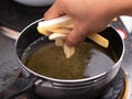 Close up of Frying french fries in the fryer in hot oil on the electric stove in the kitchen. Making homemade french fries Royalty Free Stock Photo