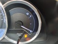 Close-up fuel gauge showing empty tank with yellow light glowing Royalty Free Stock Photo