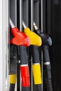 Close-up fuel nozzles on petrol and diesel fuel. Gas station pump. Man refueling gasoline with fuel in a car, holding a nozzle. Royalty Free Stock Photo