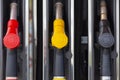 Close-up fuel nozzles on petrol and diesel fuel. Gas station pump. Man refueling gasoline with fuel in a car, holding a nozzle. Royalty Free Stock Photo