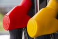 Close-up fuel nozzles on petrol and diesel fuel. Gas station pump. Man refueling gasoline with fuel in a car, holding a nozzle. Royalty Free Stock Photo