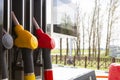 Close-up fuel nozzles on petrol and diesel fuel. Gas station pump. Man refueling gasoline with fuel in a car, holding a nozzle. Royalty Free Stock Photo