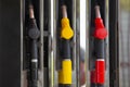 Close-up fuel nozzles on petrol and diesel fuel. Gas station pump. Man refueling gasoline with fuel in a car, holding a nozzle. Royalty Free Stock Photo