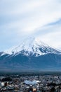 Close up Fuji Mountain in vertical against blue clods sky background ,cityscape view in front in Japan. Royalty Free Stock Photo