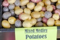 Pile of organic mixed medley rainbow potatoes background