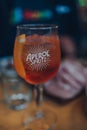 Close up of a full glass of Aperol Spritz cocktail,on an outdoor table of a restaurant