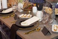Close up of a fully set banquet table with brown and earth tones Royalty Free Stock Photo