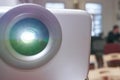 Close-up of functioning projector in bright office room with unfocused background Royalty Free Stock Photo