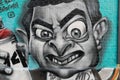 A close up of a funky Mr bean graffiti holding a spray can, Shoreditch, Uk