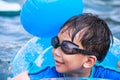 Close up funny asian boy with swim tube in pool. Outdoor. Royalty Free Stock Photo