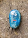 Close up of funny cartoon painted children blue stone with eyes Royalty Free Stock Photo