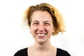 Close-up of a funny girl student with a strange hairstyle looks at the camera and smiles, on a white background. Concept