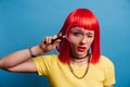 Close-up, funny portrait of a cheerful Caucasian pretty girl looking with her eye through a magnifying glass highlighted Royalty Free Stock Photo