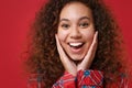 Close up of funny young african american girl in pajamas homewear posing while resting at home isolated on red Royalty Free Stock Photo