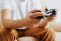 Close-up of gamer's male hands holding wireless game controller with joysticks. Royalty Free Stock Photo