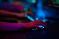 Close-up of the gamers hand movements on the glowing keyboard and mouse