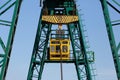 close-up of a gantry crane cabin and a hook with slings.