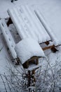 close-up of garden bench and bird table covered in thick fresh snow