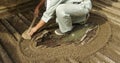 Close up of Gardener raking a Japanese Zen rock garden at Ginkakuji Temple or Silver Pavilion in Japan Royalty Free Stock Photo