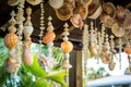 close-up of garlands made of seashells hanging from a backyard pergola