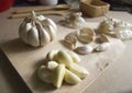 Close Up Garlic Bulb and Garlic Cloves on Wooden chopping board placed Royalty Free Stock Photo
