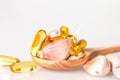 Close up garlic and oil capsule gel supplement in a wooden spoon Royalty Free Stock Photo