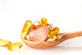 Close up garlic and oil capsule gel supplement in a wooden spoon Royalty Free Stock Photo