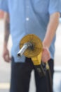 Gas station attendant holding a hose